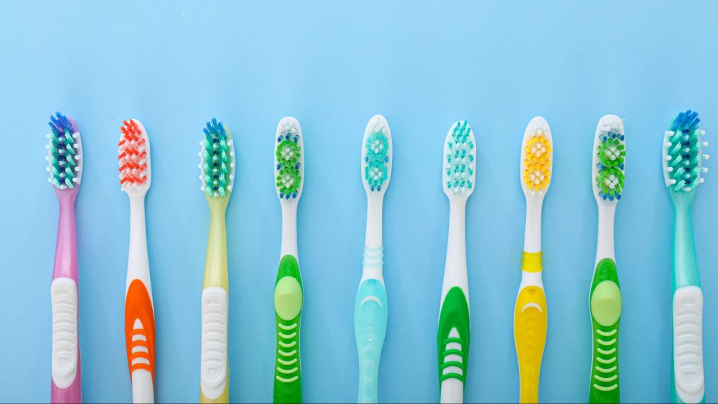 Lineup of mutli-colored toothbrushes