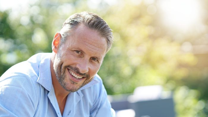 Portrait Of Smiling Mature Man Relaxing Outside