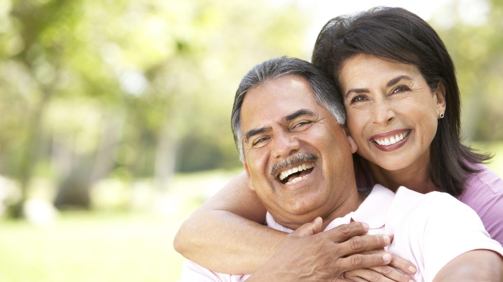 Older couple smiling outside Portage MI Dentist